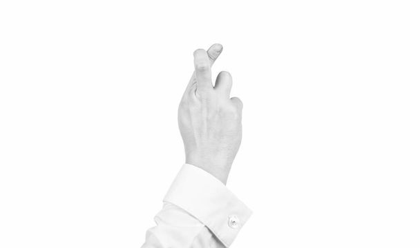skrzyżowane palce gest życzenia z męską ręką odizolowane na białe, fałszywe obietnice - Zdjęcie, obraz