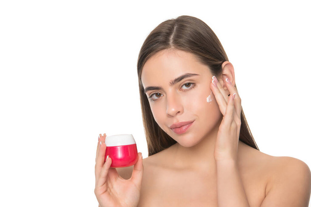 presenting female cosmetic product. woman applying face cream. young girl hold hair mask - Photo, Image