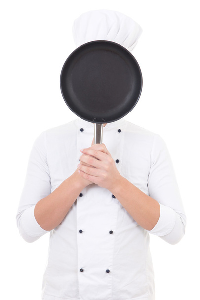 young man in chef uniform with frying pan behind his face isolat - Valokuva, kuva