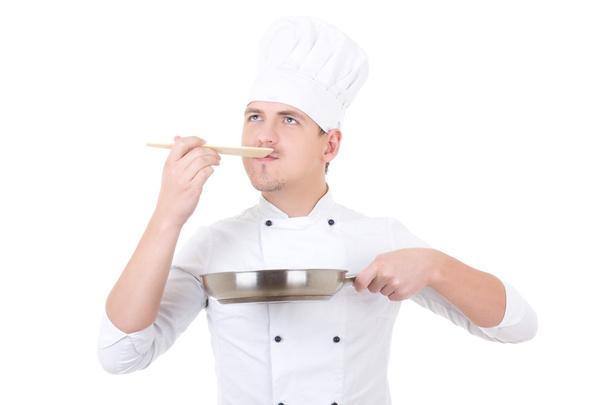 young man in chef uniform tasting something isolated on white - Photo, Image