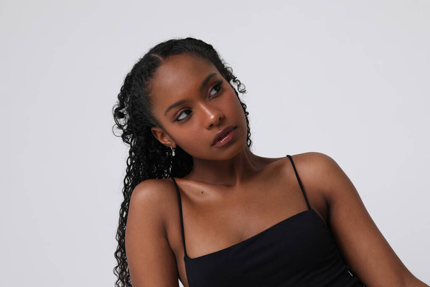 Portrait of confident African American young woman posing indoors. Isolated. - 写真・画像