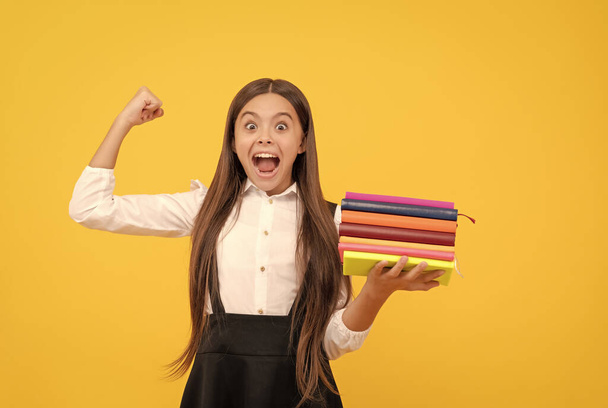 happy teen girl in school uniform hold book stack, success - Foto, Imagem