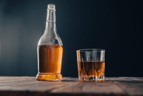 bottle and glass of alcohol on tabl - Foto, Imagem
