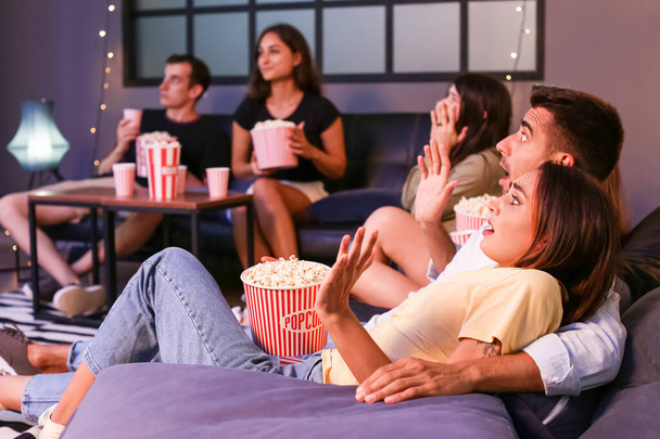 Группа друзей вечером смотрит кино дома - Фото, изображение