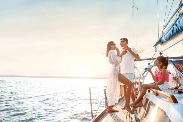 Happy young family resting on yacht - Photo, Image