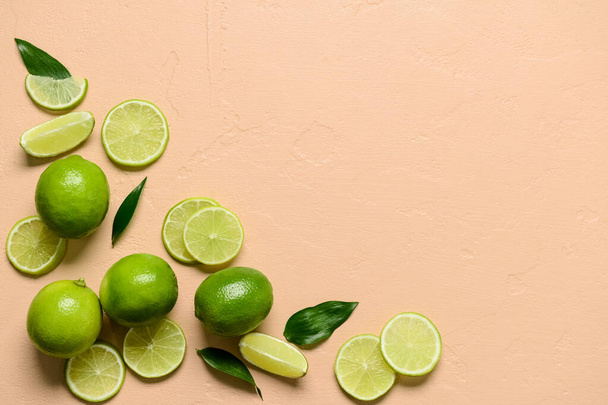 Composition with whole and cut limes on color background - Фото, изображение