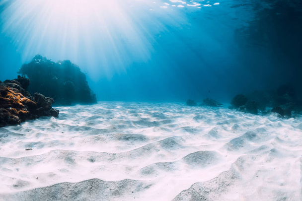 Onderwater zicht op tropische blauwe oceaan met wit zand en koralen - Foto, afbeelding