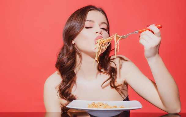 Sexy woman eat tasty pasta. Food from Italia. Spaghetti. Italian cuisine concept. Healthy menu. - Foto, Bild