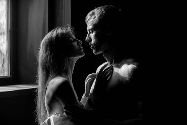 Closeup face of a beautiful young couple in love embracing in bedroom, romance and and affection. - 写真・画像