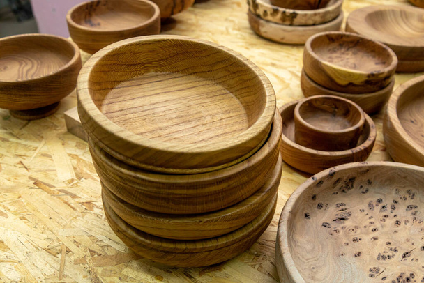 Handmade wooden bowls on a table - Fotoğraf, Görsel