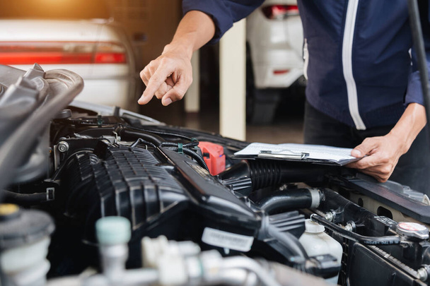 Automobile mechanic repairman hands repairing a car engine automotive workshop with a wrench, car service and maintenance, Repair service. - Foto, Imagen