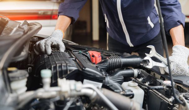 Automobile mechanic repairman hands repairing a car engine automotive workshop with a wrench, car service and maintenance, Repair service. - Fotoğraf, Görsel