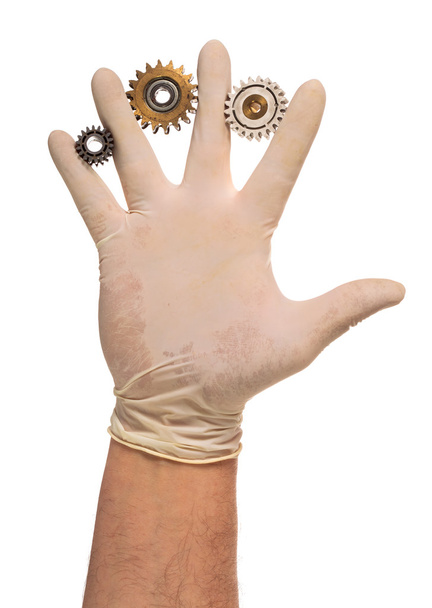 Guante de mano en látex con engranajes usados
 - Foto, Imagen