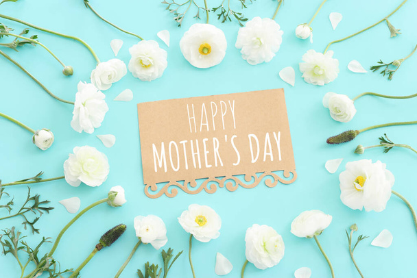 mother's day concept with white flowers over blue pastel background - Фото, зображення