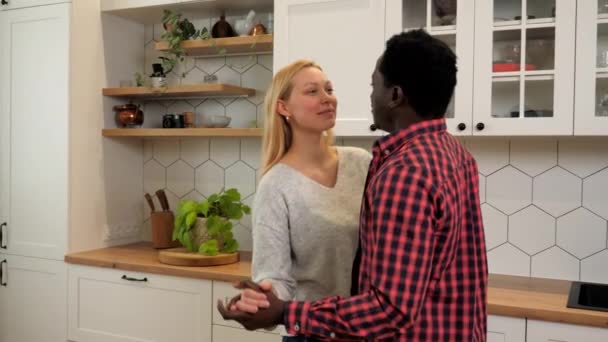 Multiethnic family couple in love listening to music slow dance at home kitchen - Filmmaterial, Video
