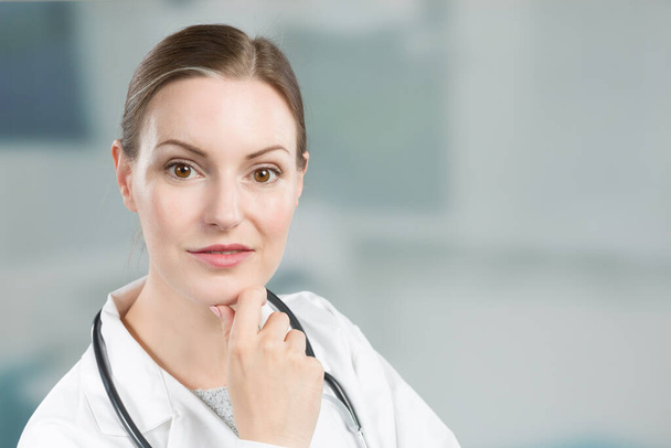 Portrait of a female likable family doctor in doctor's overall with stethoscope  - Photo, Image