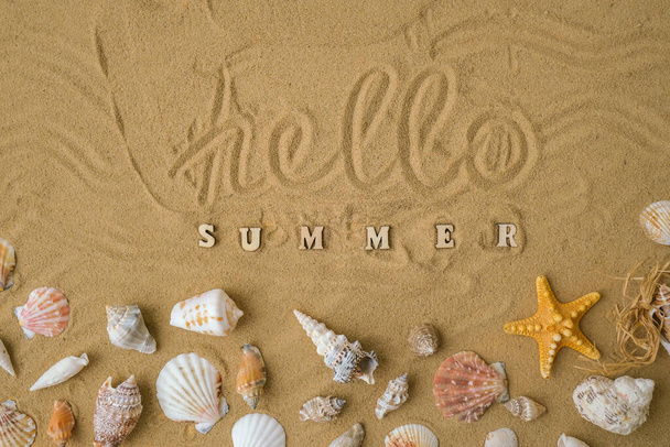 Composition with text HELLO SUMMER seashells, pebbles, mockup on sand background. Blank, top view, still life, flat lay. Sea vacation travel concept tourism and resorts. Summer holidays - Foto, imagen