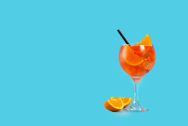 Glass of aperol spritz cocktail on blue background. Copy space - Photo, Image