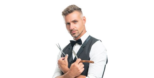 serious man barber with razor blade and scissors in bow tie isolated on white background - Fotoğraf, Görsel