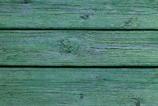 Texture of old painted wood. The old paint has peeled off the wood. - Fotó, kép