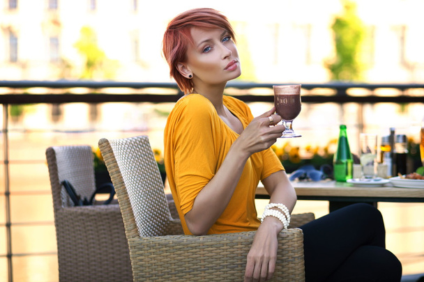 Beautiful redhead woman drinking coffe on sunny day - Foto, Imagen
