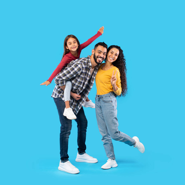 Cheerful Middle Eastern Family Having Fun Posing Over Blue Background - 写真・画像