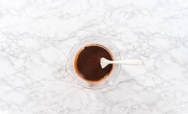Flat lay. Preparing chocolate ganache in a glass mixing bowl. - Photo, image