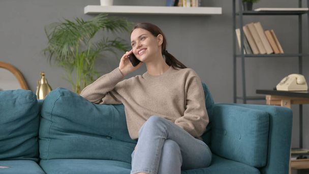 Woman Talking on Phone on Sofa  - Foto, immagini
