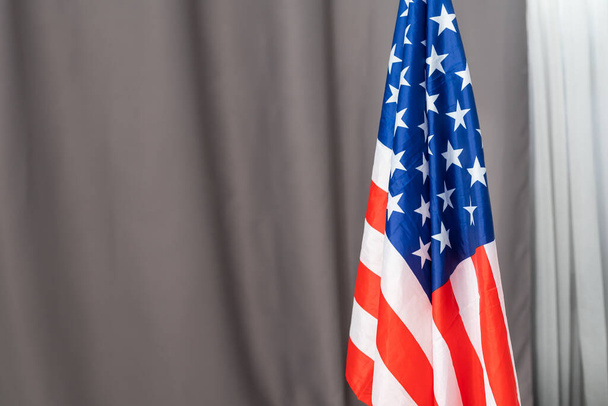 Closeup of American flag on plain background - 写真・画像