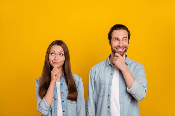 Photo of smart millennial brown hairdo couple look promo wear jeans shirts isolated on yellow background - Valokuva, kuva