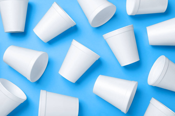 White styrofoam cups on light blue background, flat lay - Fotoğraf, Görsel