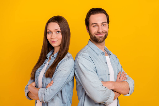 Photo of cheerful pretty sister brother dressed denim shirts arms crossed smiling isolated yellow color background - Foto, immagini