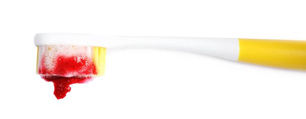 Toothbrush with paste and blood on white background, top view. Gum inflammation - Foto, Imagen