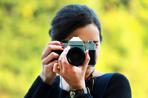 Young woman taking a picture with an old camera - Photo, Image