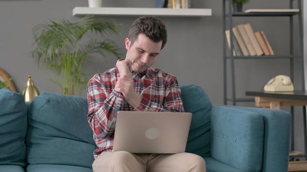 Man with Laptop having Wrist Pain on Sofa  - Photo, Image