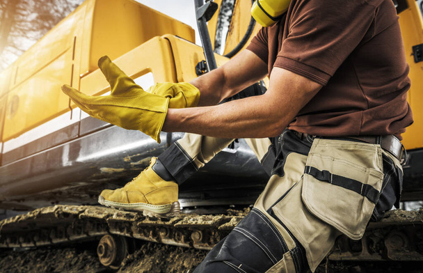 Heavy Construction Equipment Caucasian Operator Wearing Safety Gloves. Bulldozer or Crawler Operator at Work. Industrial Theme. - Photo, Image