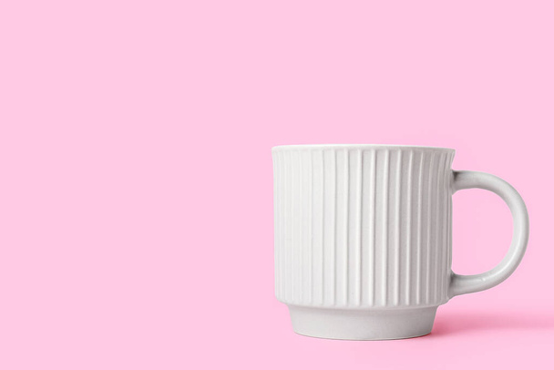 Ceramic cup on pink background - 写真・画像