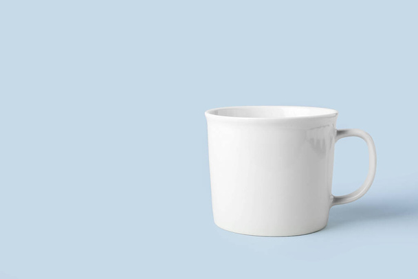 Empty ceramic cup on light background - Foto, afbeelding