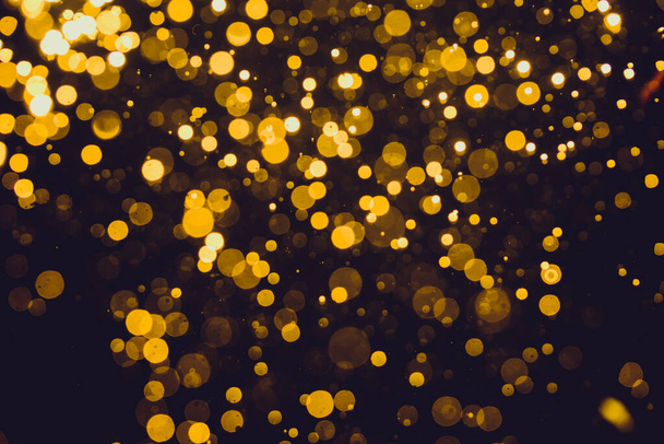 Абстрактне золото осквернило боке світла на темному фоні
 - Фото, зображення