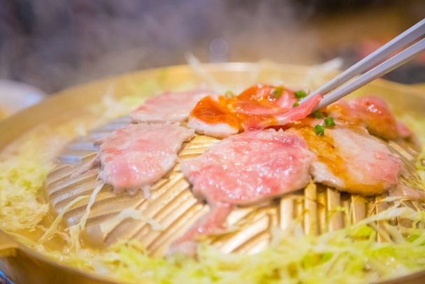 Pork slides grill food in a brass pan with cabbage vegetable - Fotografie, Obrázek