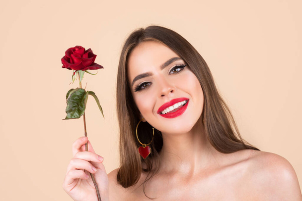Beauty woman with red rose. Fashion girl face with rose in hand. Red lips. Vogue spring summer style. Birthday day. - Foto, immagini