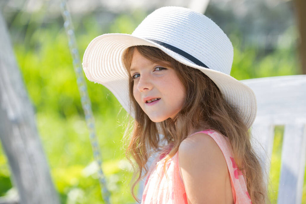 Happy child face. Child teen girl has summer joy. Happy day. Cute playful cheerful kid with funny face. Cute little girl swinging on the meadow in summer day. Portrait of cute teen girl in summer. - 写真・画像