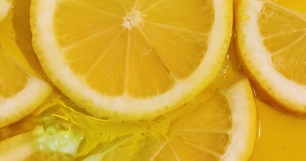 Top view rotation of fresh slice of lemons juice and gel serum pours, organic cosmetics, vitamin C, fresh citrus fruits, Lemon extract - Filmagem, Vídeo