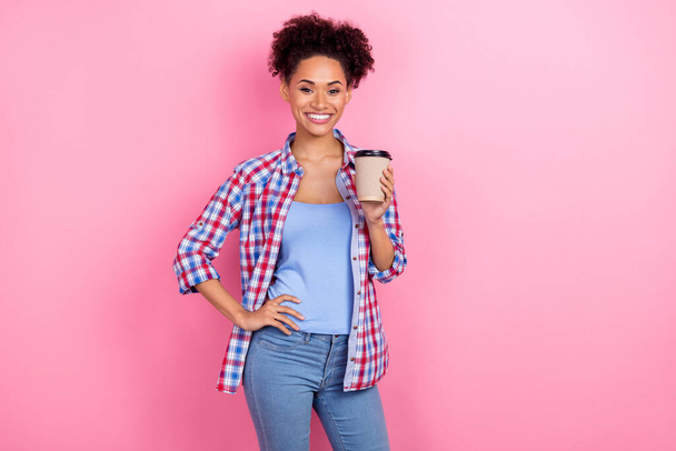 Photo of pretty brunette lady drink cacao wear blue shirt jeans isolated on pink color background - 写真・画像