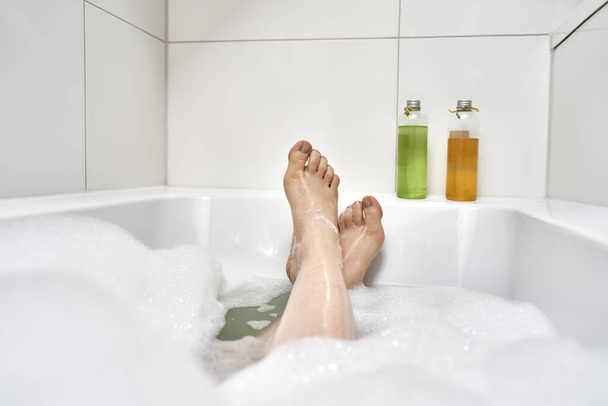 Close up of women's feet in bathtub in the morning  - Foto, Imagen
