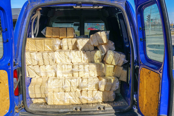 Packages of wood sawdust briquettes loaded in a car, alternative fuel, eco fuel, bio fuel with good heat output - Foto, immagini