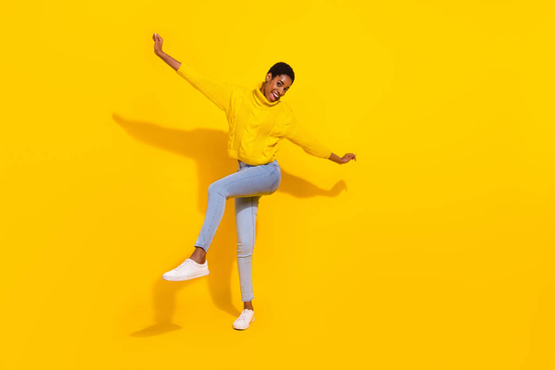 Full length body size view of attractive cheerful thin carefree girl dancing having fun day isolated over bright yellow color background - Fotó, kép