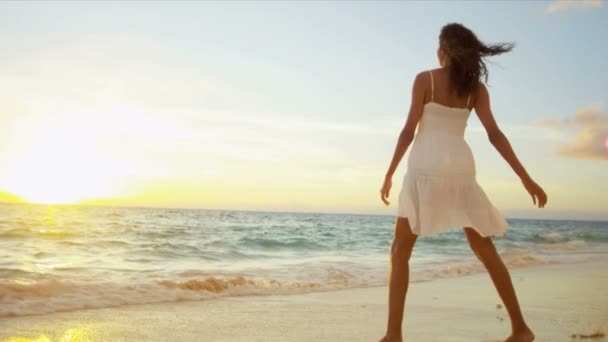 Chica en vestido blanco caminando en la playa de arena
 - Imágenes, Vídeo