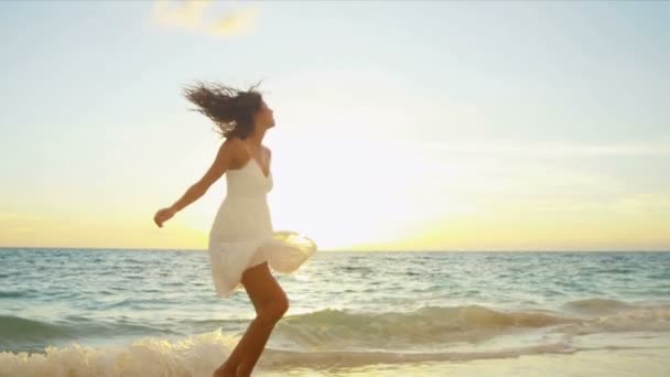 Carefree girl enjoying at beach by the  ocean - Footage, Video