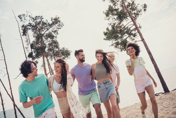 Photo of funny charming six young buddies dressed casual outfits walking embracing communicating smiling outdoors countryside - Photo, image